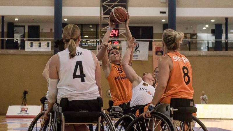 women in wheelchairs contest basketball