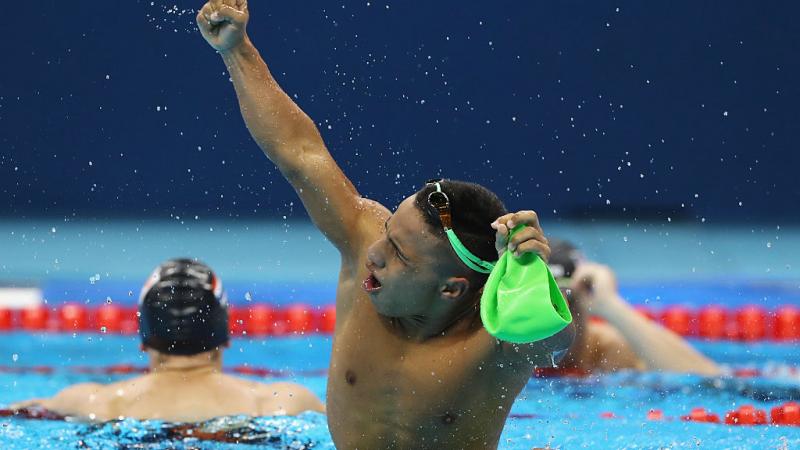 a para swimmer celebrates in the pool