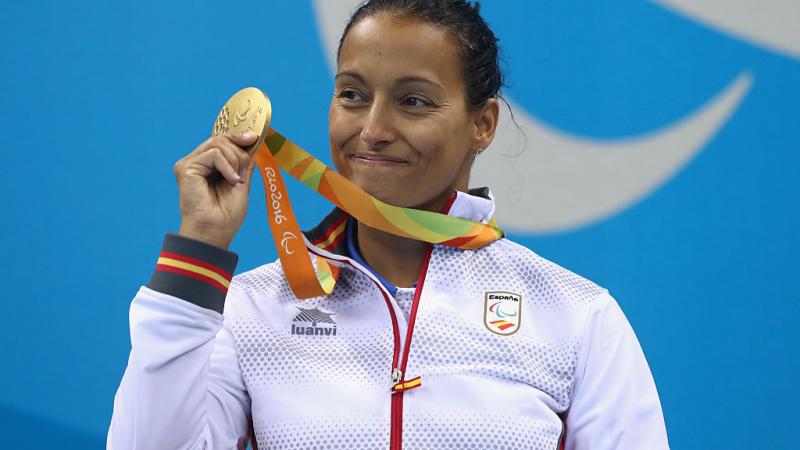 a Para swimmer celebrates with her medal