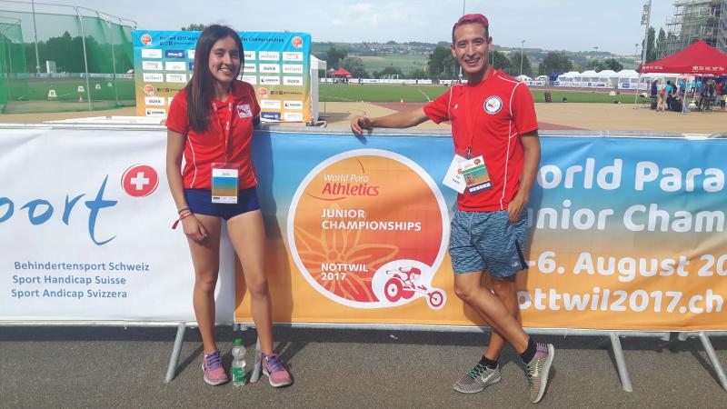 Man and woman pose for a photo on the track