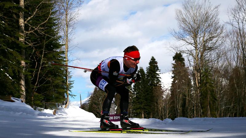 A male Para cross country skier skies across the snow