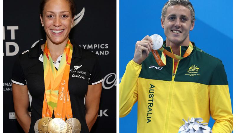A male and a female swimmer pose with their medals