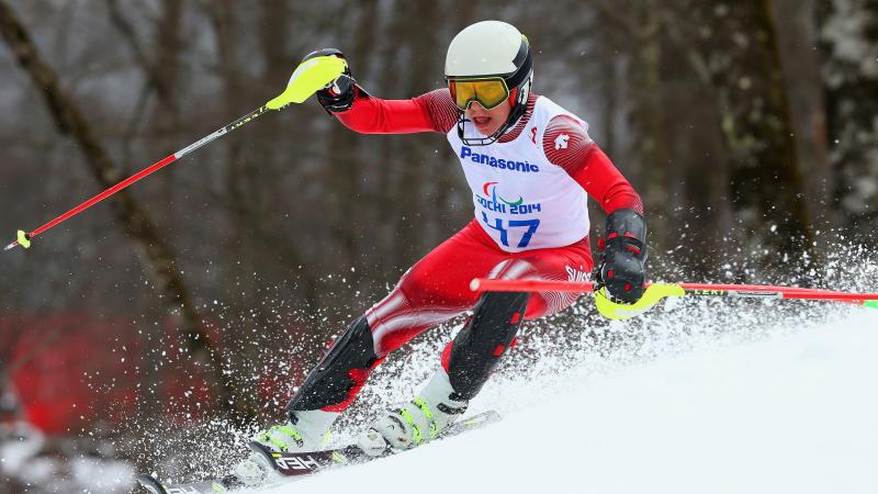 a male Para skier goes down the slope