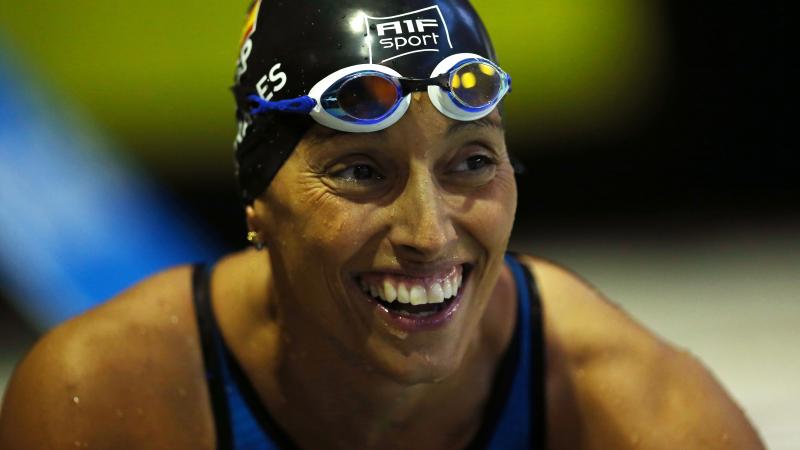 a female Para swimmer smiling in the pool