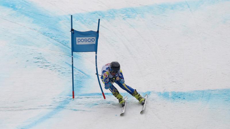 Alpine skier skies down a hill