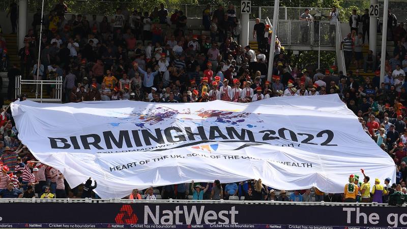 a huge flag is held up by a crowd of cricket supporters
