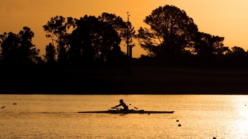 Sunset photo of rower in a boat on the water