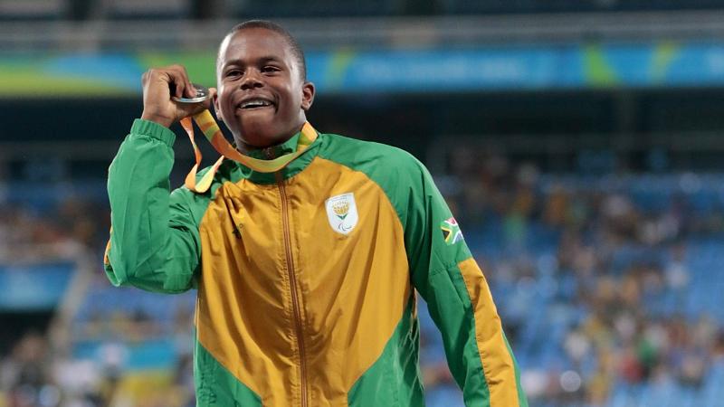 Silver medalist Ntando Mahlangu of South Africa celebrate on the podium at the medal ceremony for the Men's 200m T42 Final at the Rio 2016 Paralympic Games.