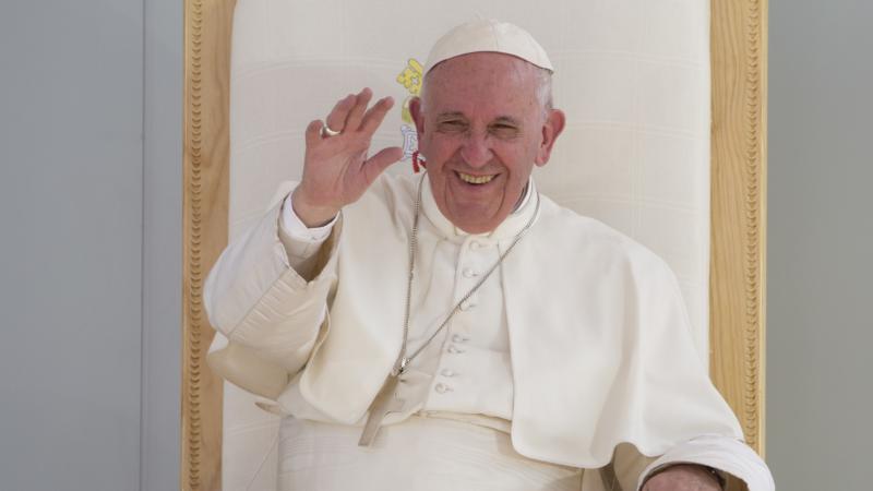 The Pope laughing his chair
