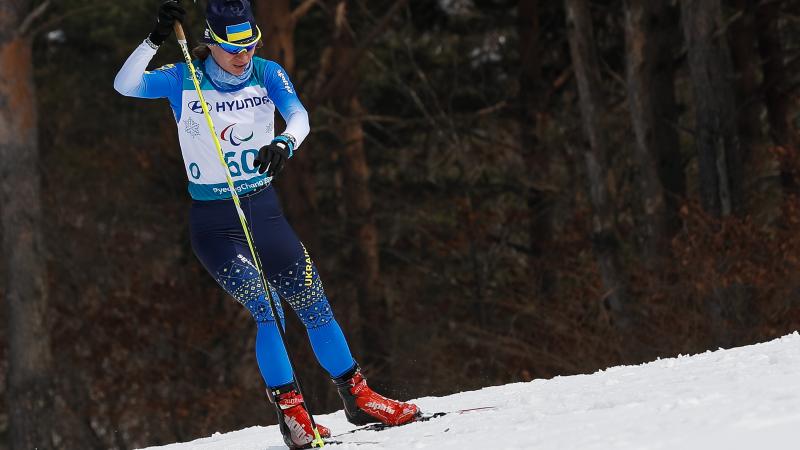 a female standing Nordic skier
