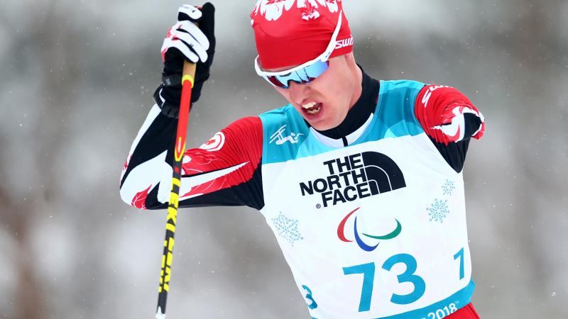 a male Para Nordic skier ploughs through the snow