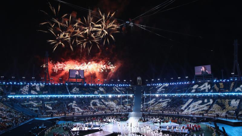 a stadium with fireworks exploding above it