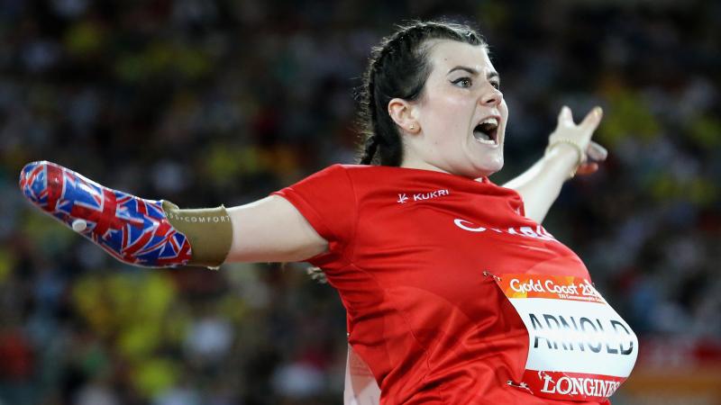 a female thrower screams as she throws her javelin
