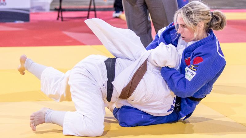 two female judokas in action on the mat