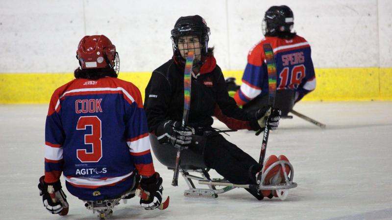 Para ice hockey athlete talks to coach during training camp in Czech Republic 