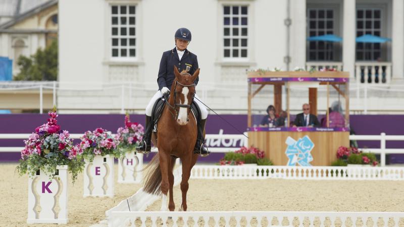 a female Para equestrian rider on her horse performing dressage