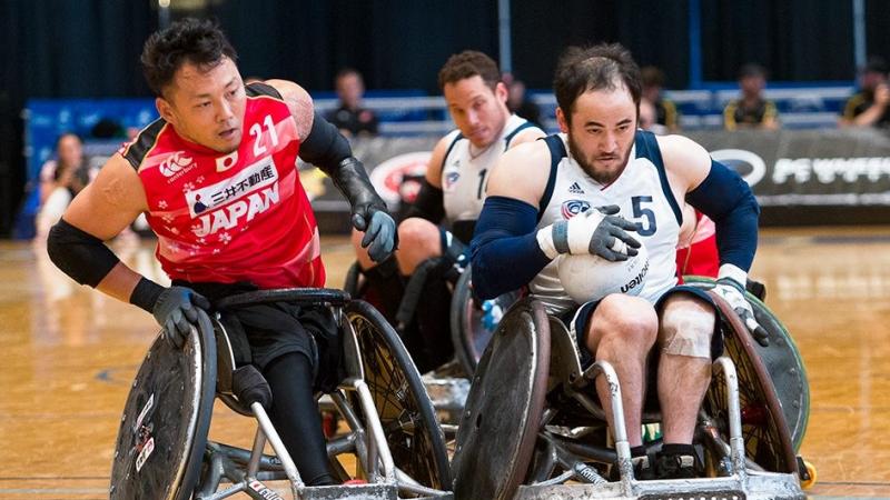 two male wheelchair rugby players clash on the court