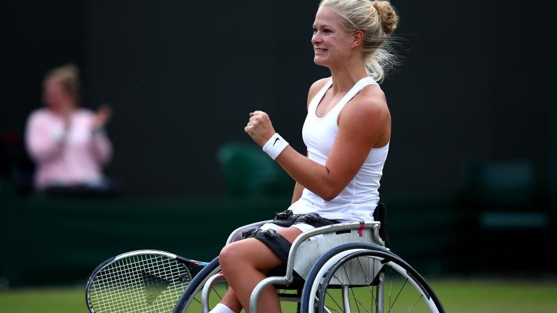female wheelchair tennis player Diede de Groot plays a shot on grass