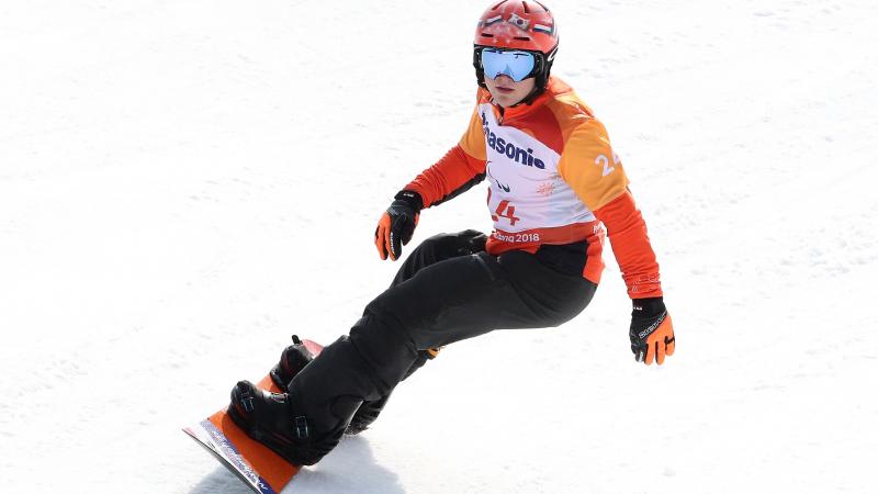 Dutch male athlete rides snowboard down a slope