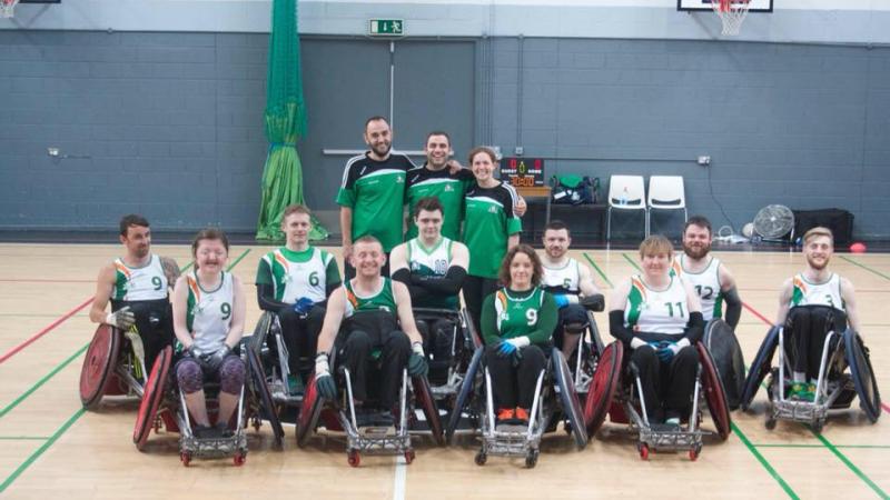 the Ireland male and female wheelchair rugby team smiling on a court