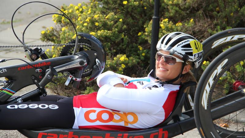 female Para cyclist Ursula Schwaller using a hand bike on the road