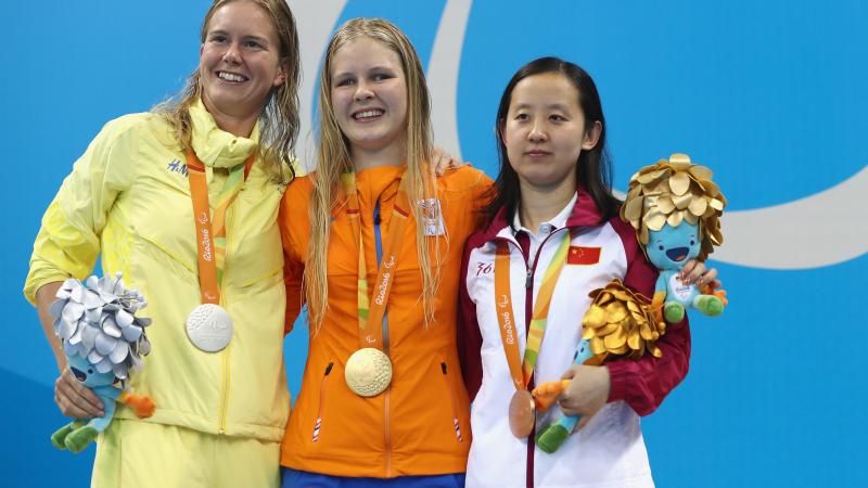 three female Para swimmers including Liesette Bruinsma and Maja Reichard on the podium with their medals  
