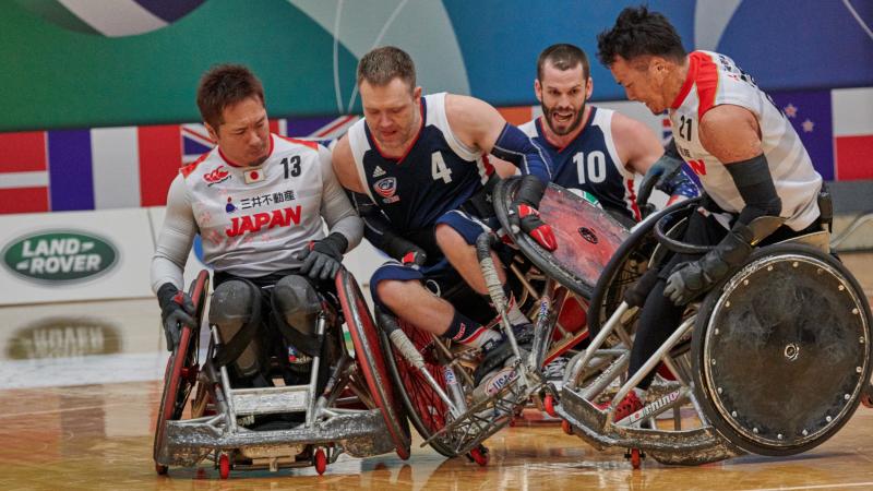 male wheelchair rugby players from USA and Japan clash on the court