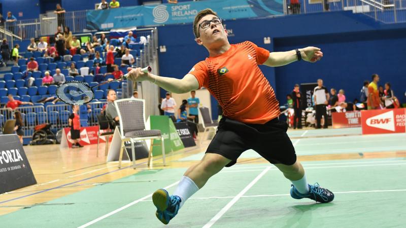 male Para badminton player Vitor Goncalves Tavares plays a forehand