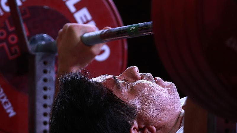 male powerlifter Majid Farzin prepares to lift the bar