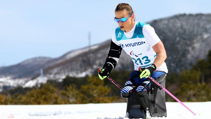 female Nordic skier Oksana Masters competess on the snow