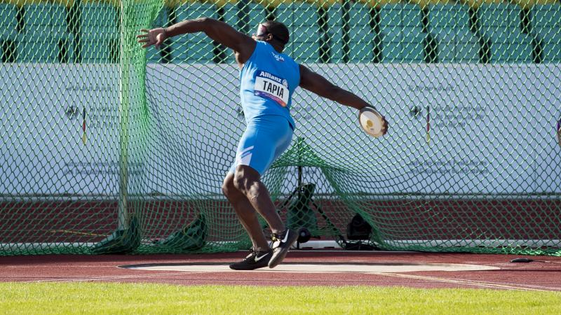 male Para athlete Oney Tapia prepares to throw a discus