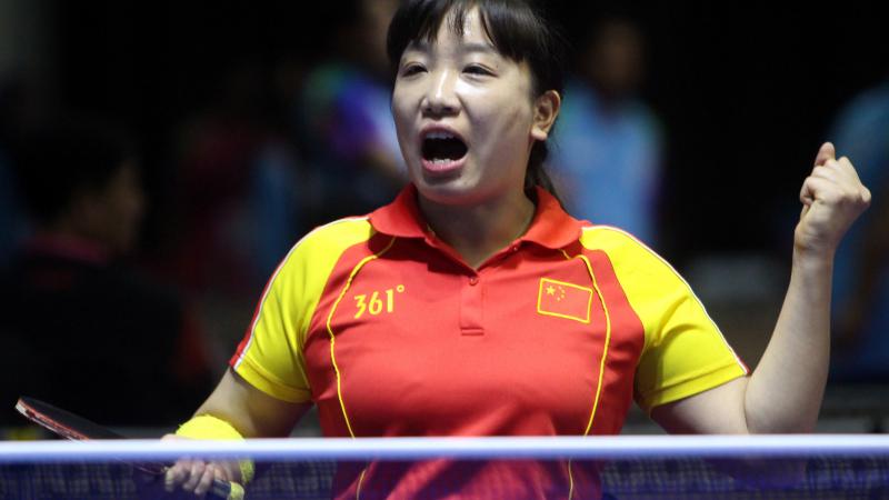 female Para table tennis player Xue Juan clenches her fist and shouts in celebration