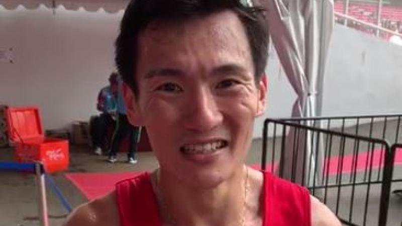 male Para athlete Zac Leow Zi Xiang smiles at the camera