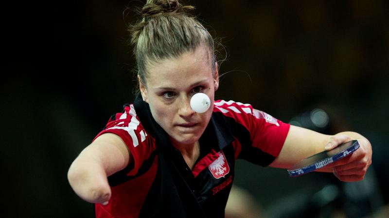 Natalia Partyka competing at the Para Table Tennis World Championships, holding the bat and watching the ball closely