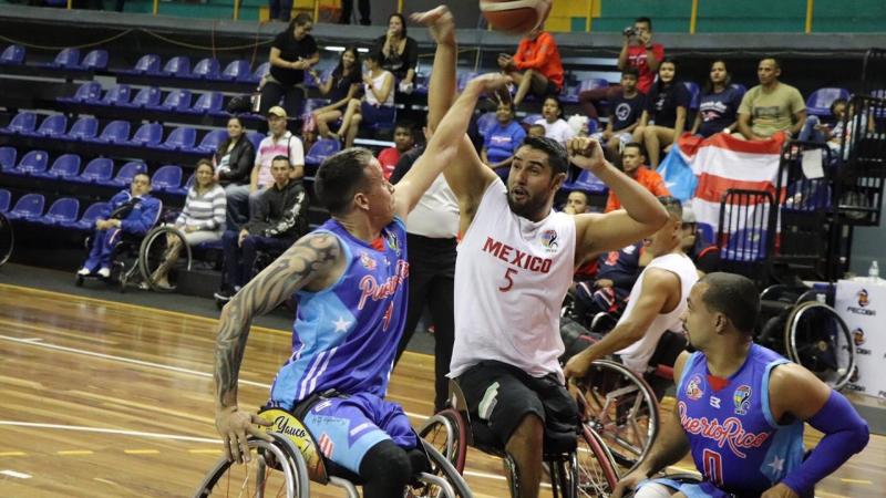 male wheelchair basketballers from Mexico and Puerto Rico fight for the ball