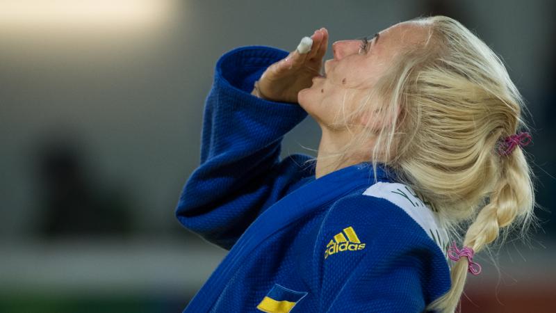 female judoka Yuliya Halinska blows a kiss to the sky