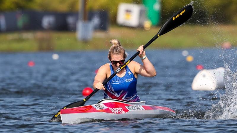 female Para canoeist Charlotte Henshaw makes a stroke through the water