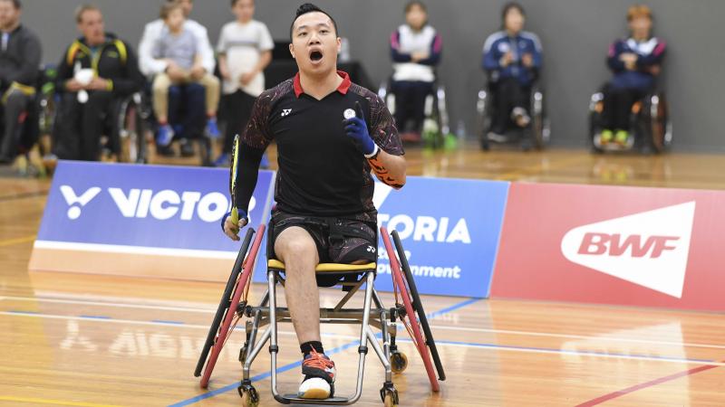 male Para badminton player Chan Ho Yuen punches the air after a winning shot