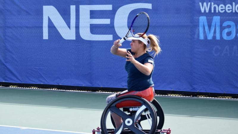 female wheelchair tennis player Giulia Capocci plays a forehand on a hard court