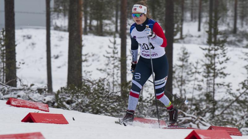 female Para Nordic skier Vilde Nilsen standing and skiing through the snow