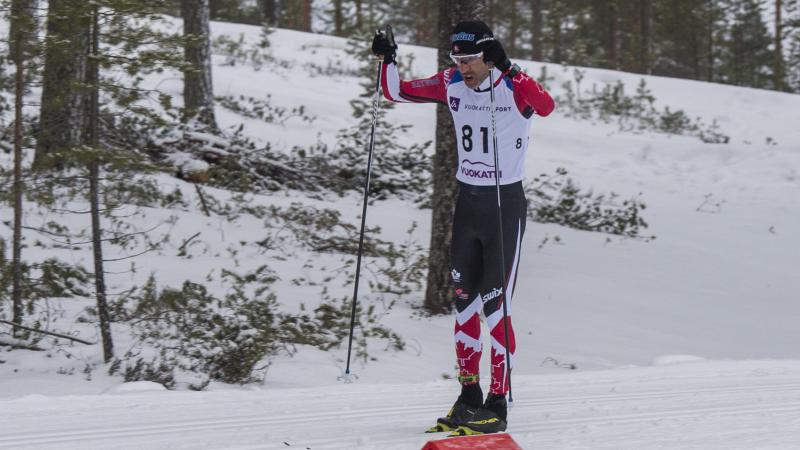 male Para Nordic skier Brian McKeever stands on skis 