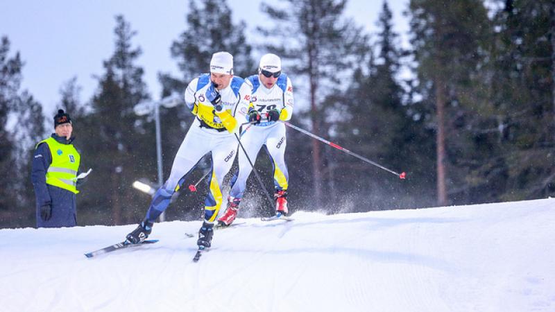 Swedish vision impaired skier follows behind his guide