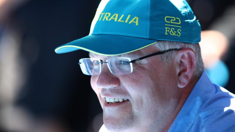 Scott Morrison wearing an Australia baseball cap and smiling