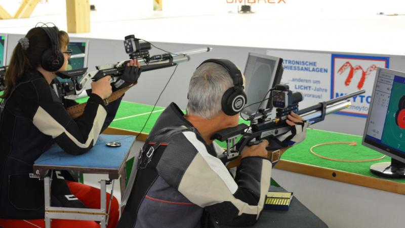 A female and a male vision impaired shooters competing 