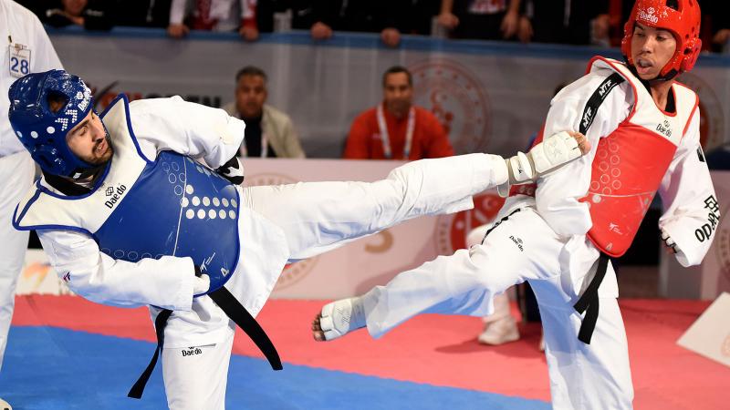 male Para taekwondo fighter Rachid Ismaili Alaoui kicks another fighter in the chest