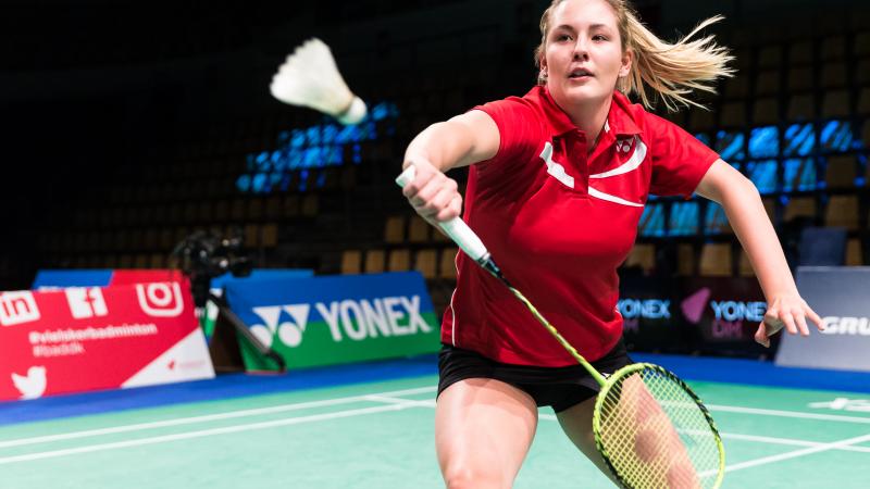 female Para badminton player Cathrine Rosengren reaches to play a backhand