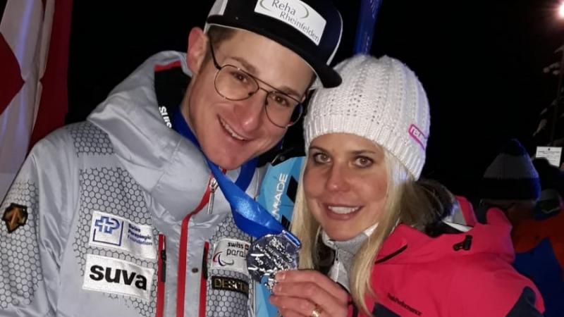 male Para alpine skier Thomas Pfyl hugs his wife Evelyn while both smile