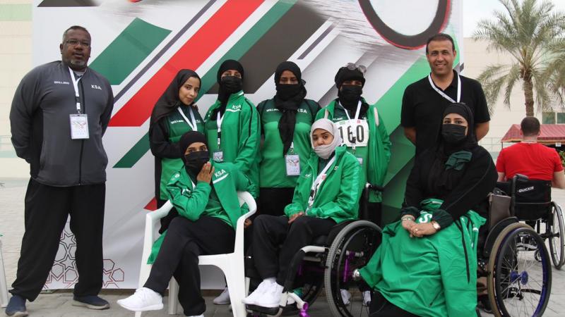 a group of female Saudi Arabian Para athletes and their two male coaches