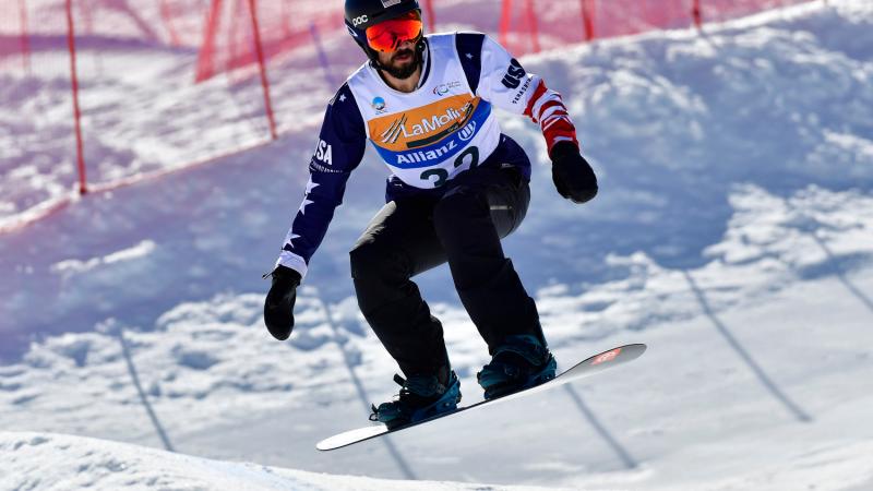 A male Para snowboarder competing