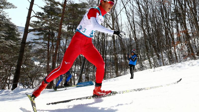 male Para Nordic skier Taiki Kawayoke skis through the forest